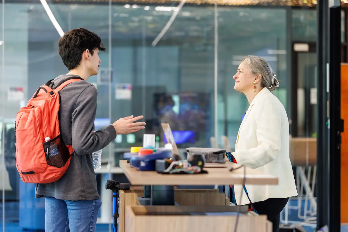 A student and instructor discussing a display at a UT Martin STEMinar.